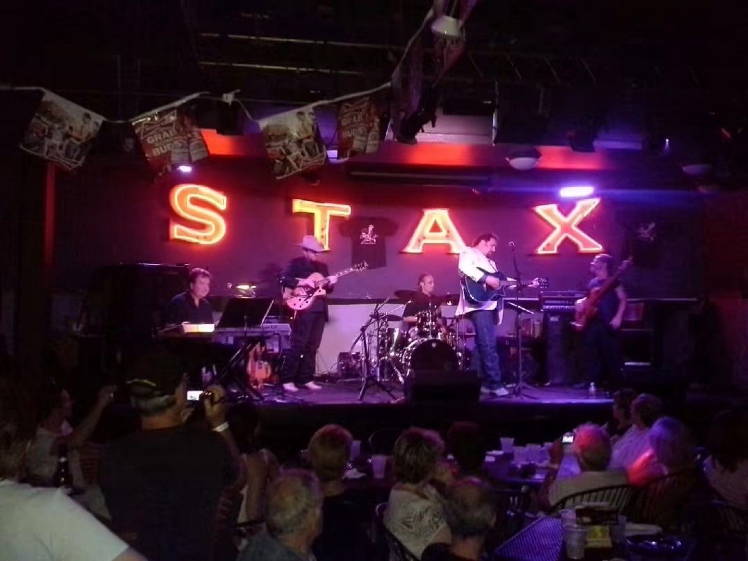 Steven Kent with the band under the STAX neon