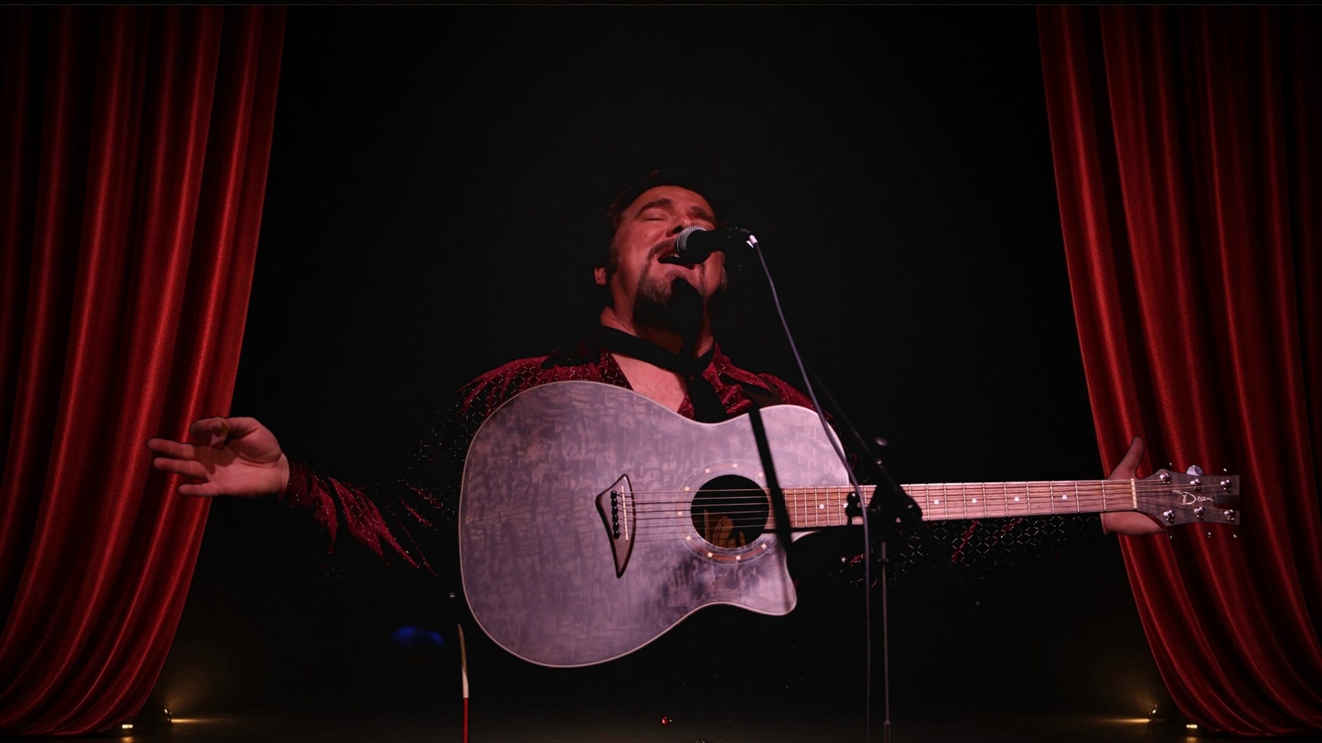 Steven Kent on the King set — red drapes, guitar, Cash & King